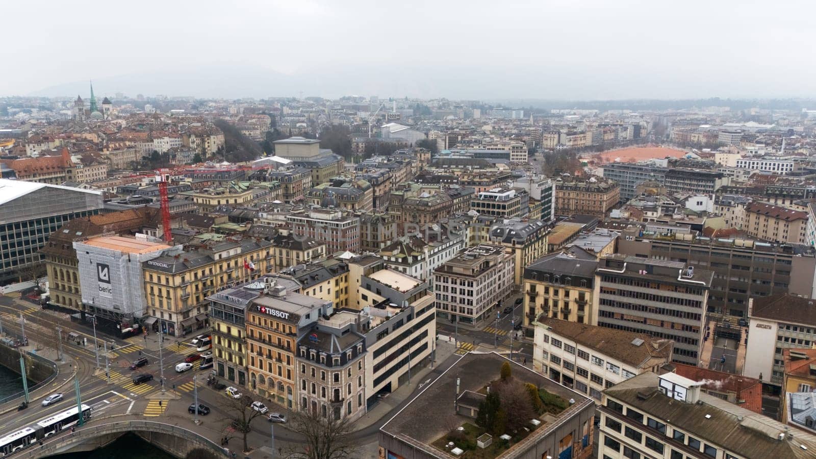 Geneve, Switzerland 04.11.2025 Drone photo capturing a densely built European city, featuring narrow streets, varied architecture, and cathedral towers rising in the distance.
