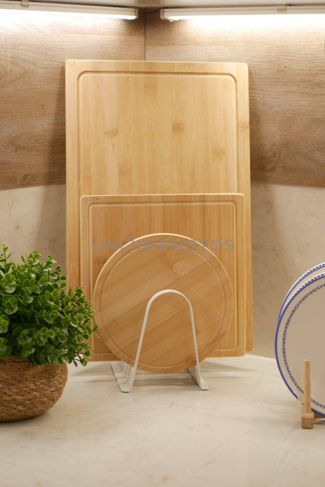 A display of wooden cutting boards arranged on a kitchen countertop.
