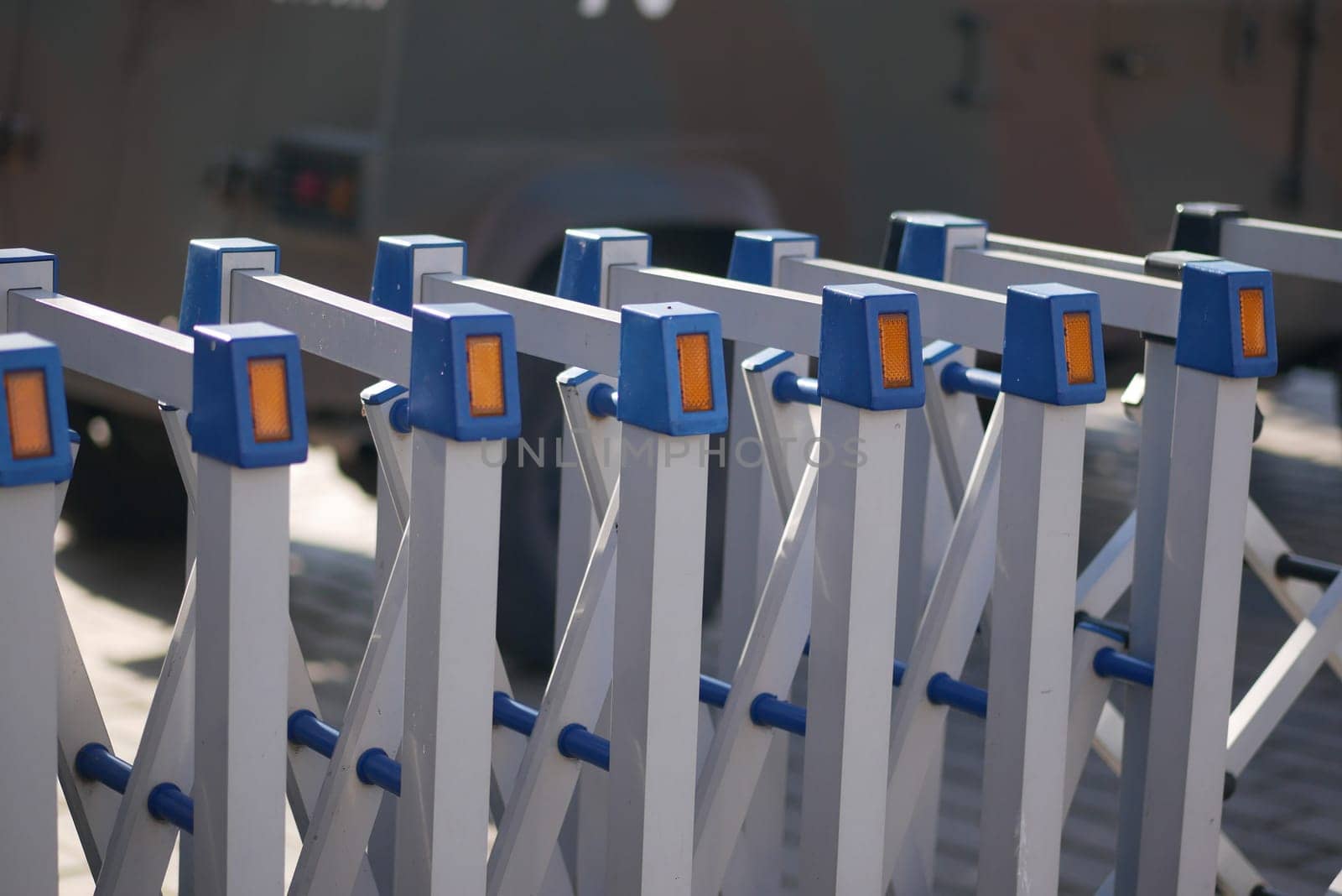 Cluster of metal barriers lined up, designed for crowd management outside.