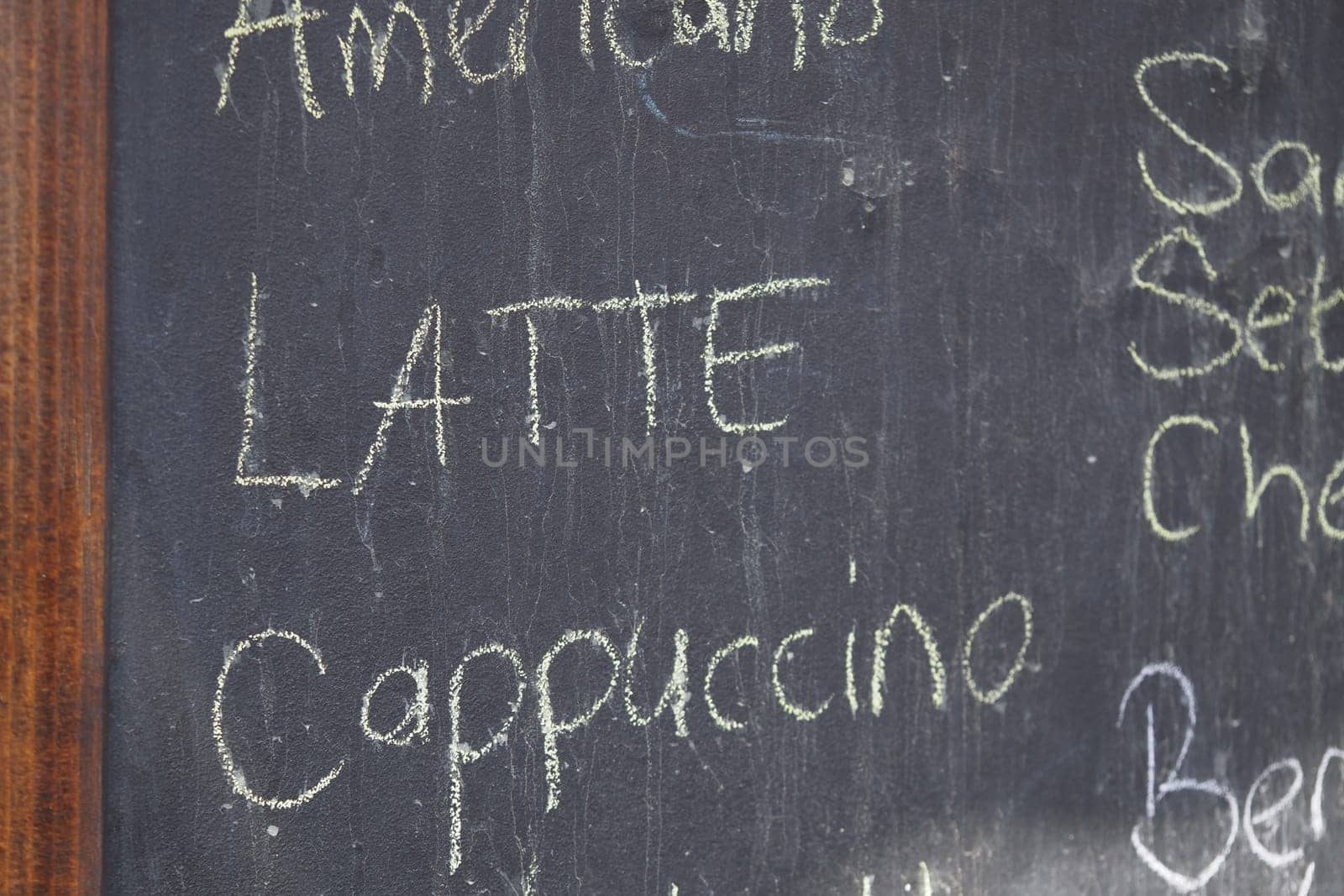 The menu displays popular coffee beverages written in chalk.