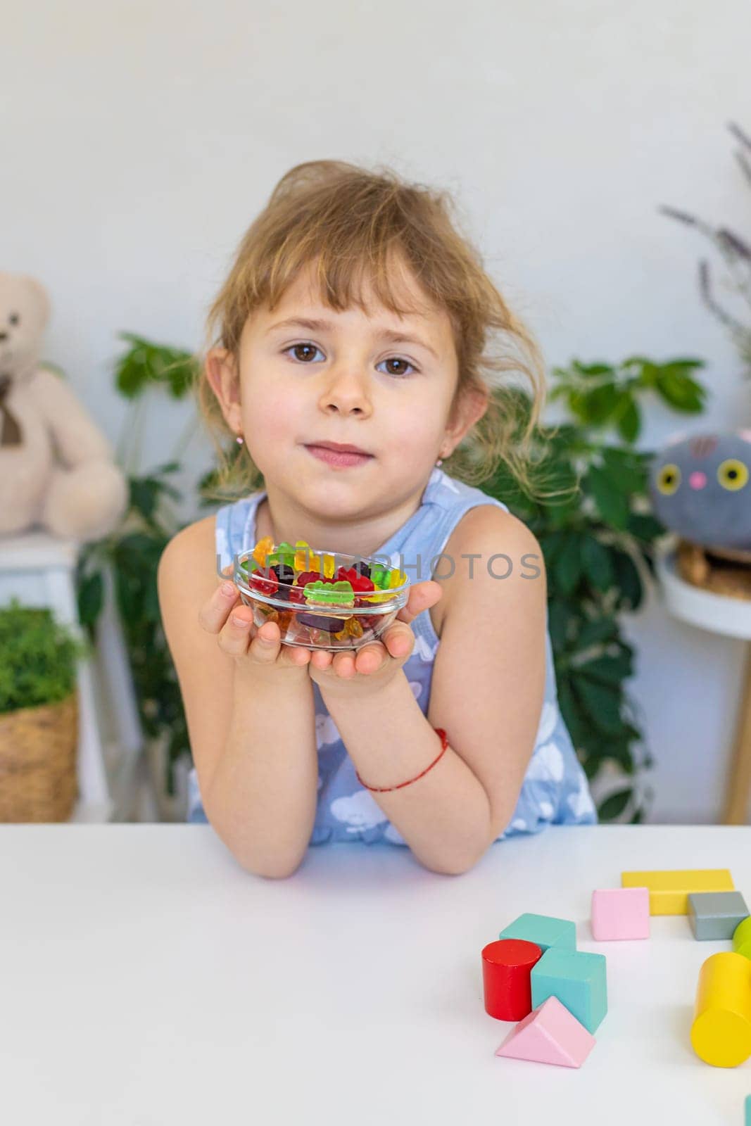 Child with jelly candies. Selective focus. kid.