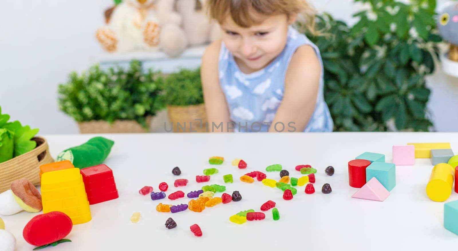 Child with jelly candies. Selective focus. kid.