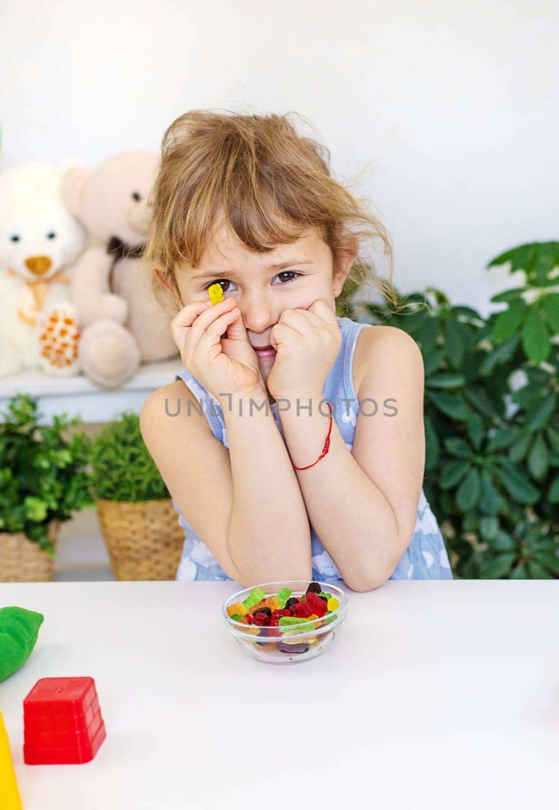 Child with jelly candies. Selective focus. kid.
