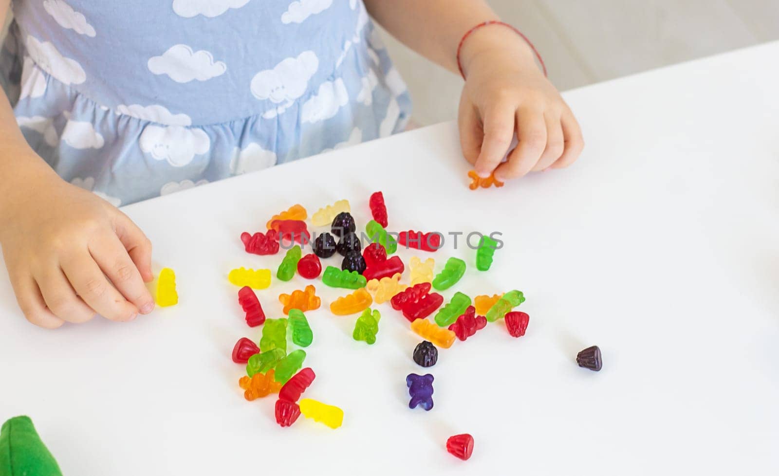 Child with jelly candies. Selective focus. kid.