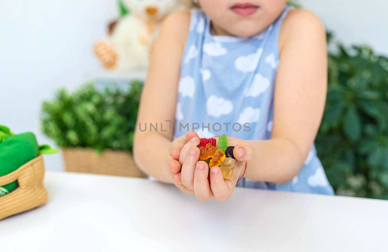 Child with jelly candies. Selective focus. kid.