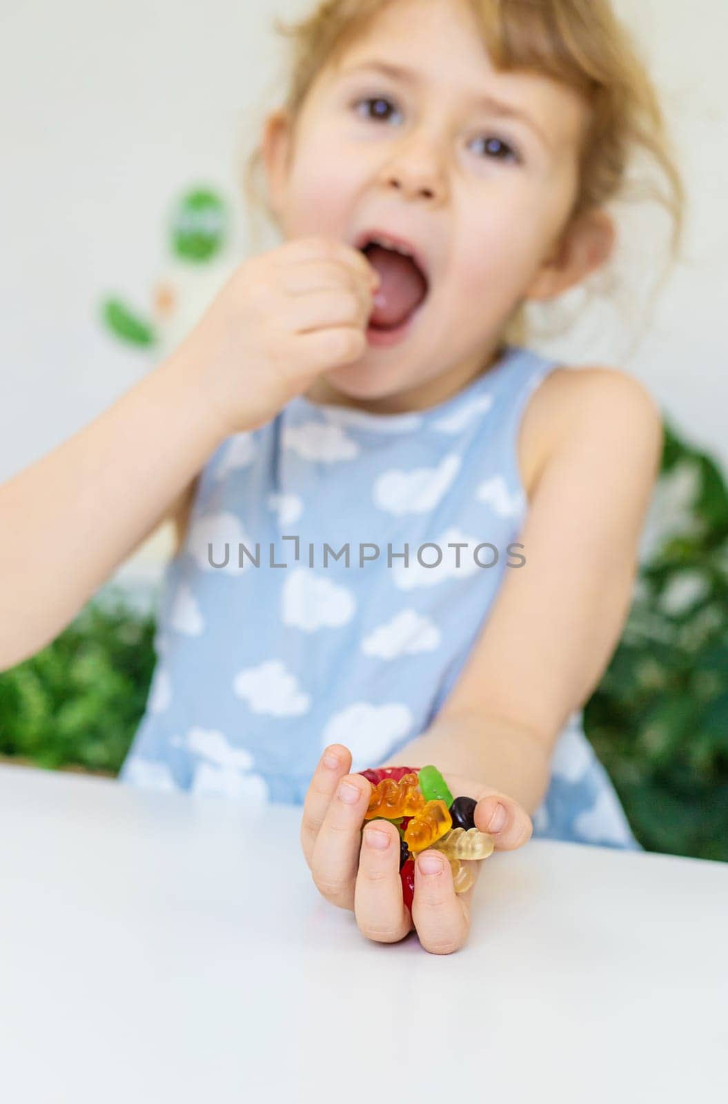 Child with jelly candies. Selective focus. kid.