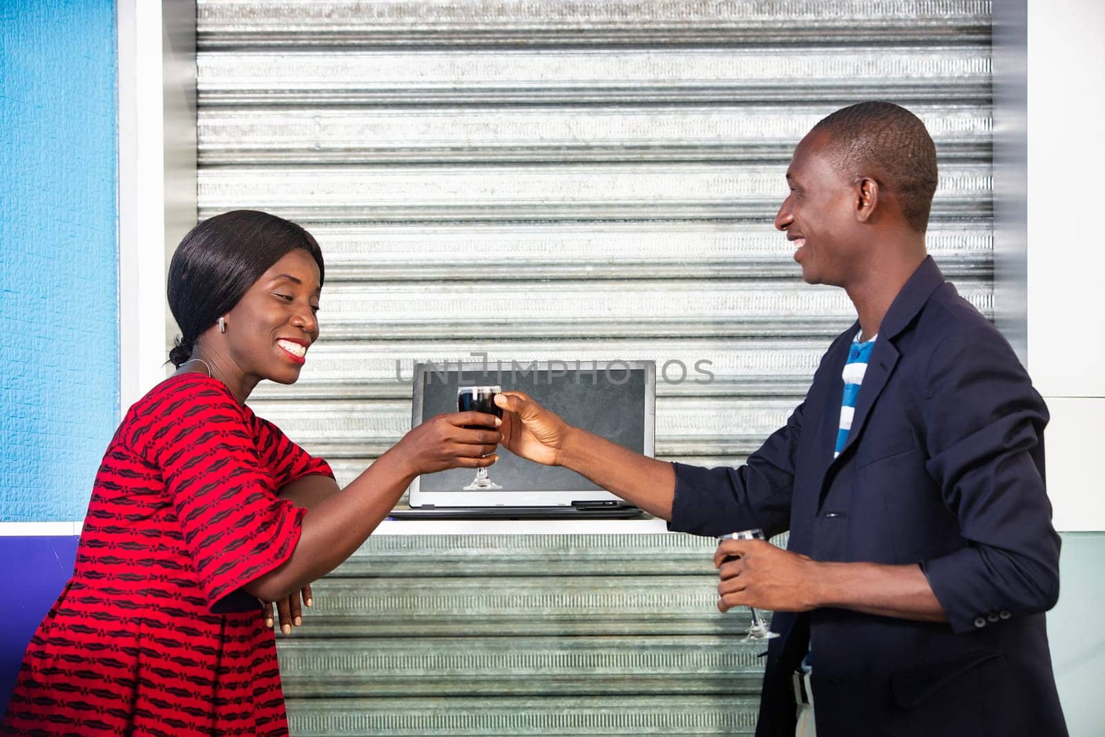 Group of african business people tasting red wine after a meeting working on new projects smiling outdoors