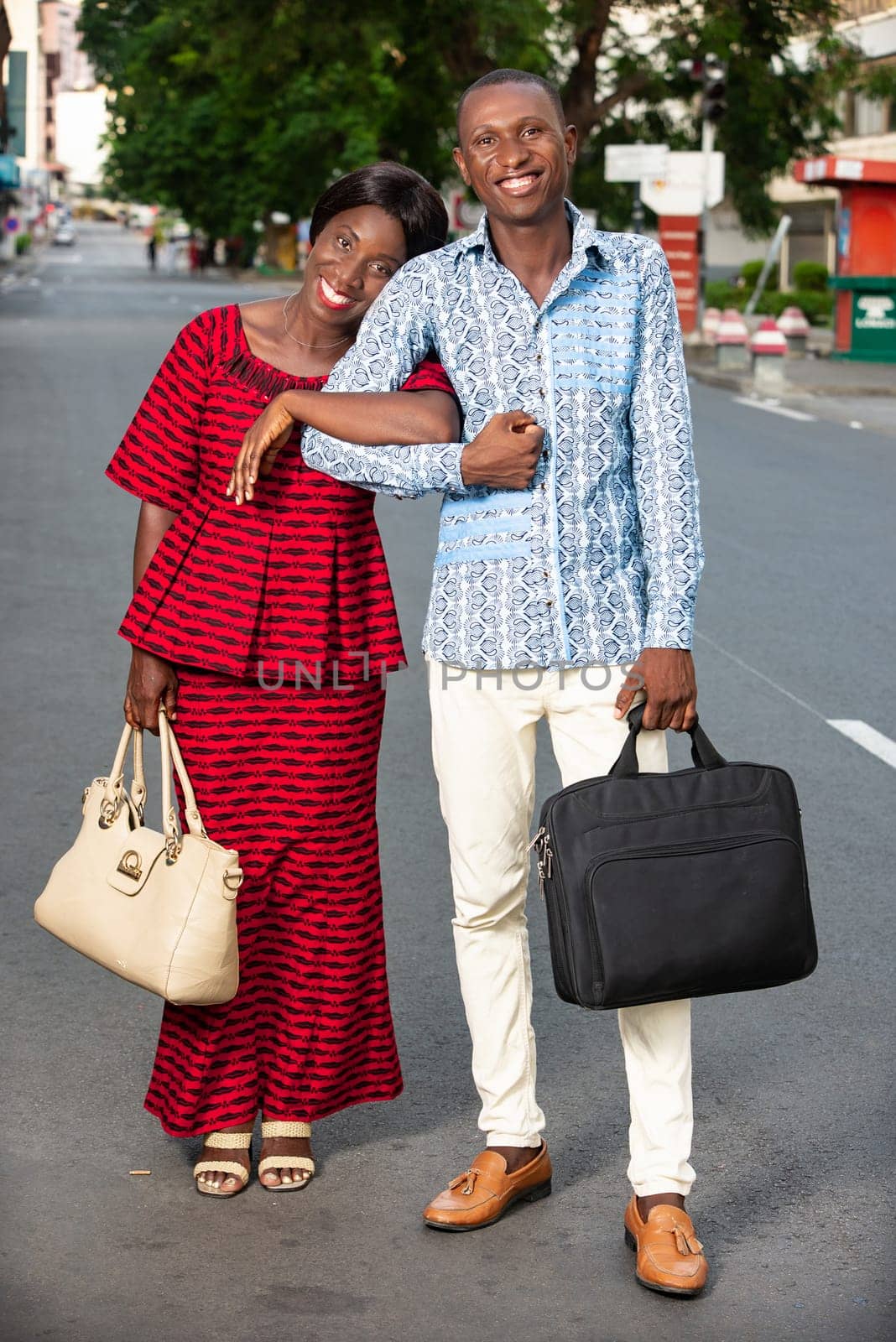 Businessman and businesswoman walking together on the street being all happy