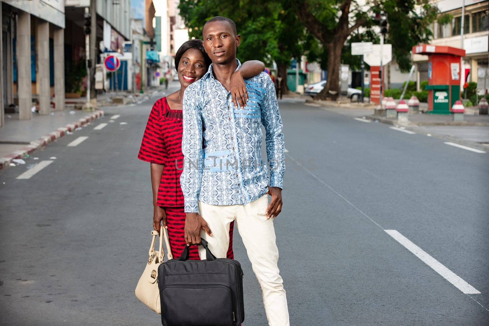 handsome african adult business partner coming down from work in the evening