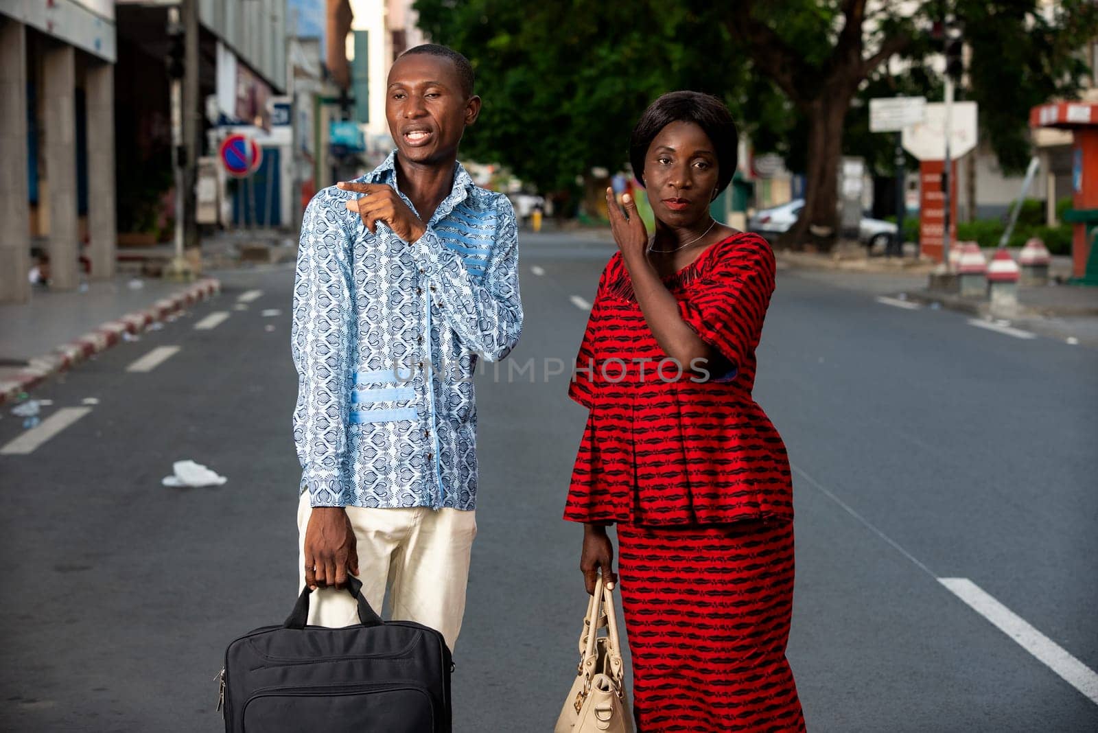 adult business people discussing doing each one an outdoor gesture in the street smiling