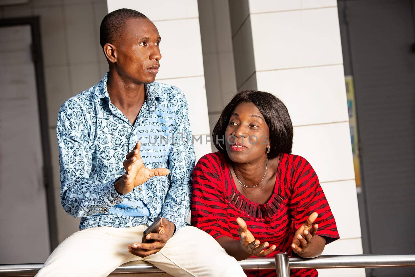 two business people in traditional clothes doing outdoor meeting.