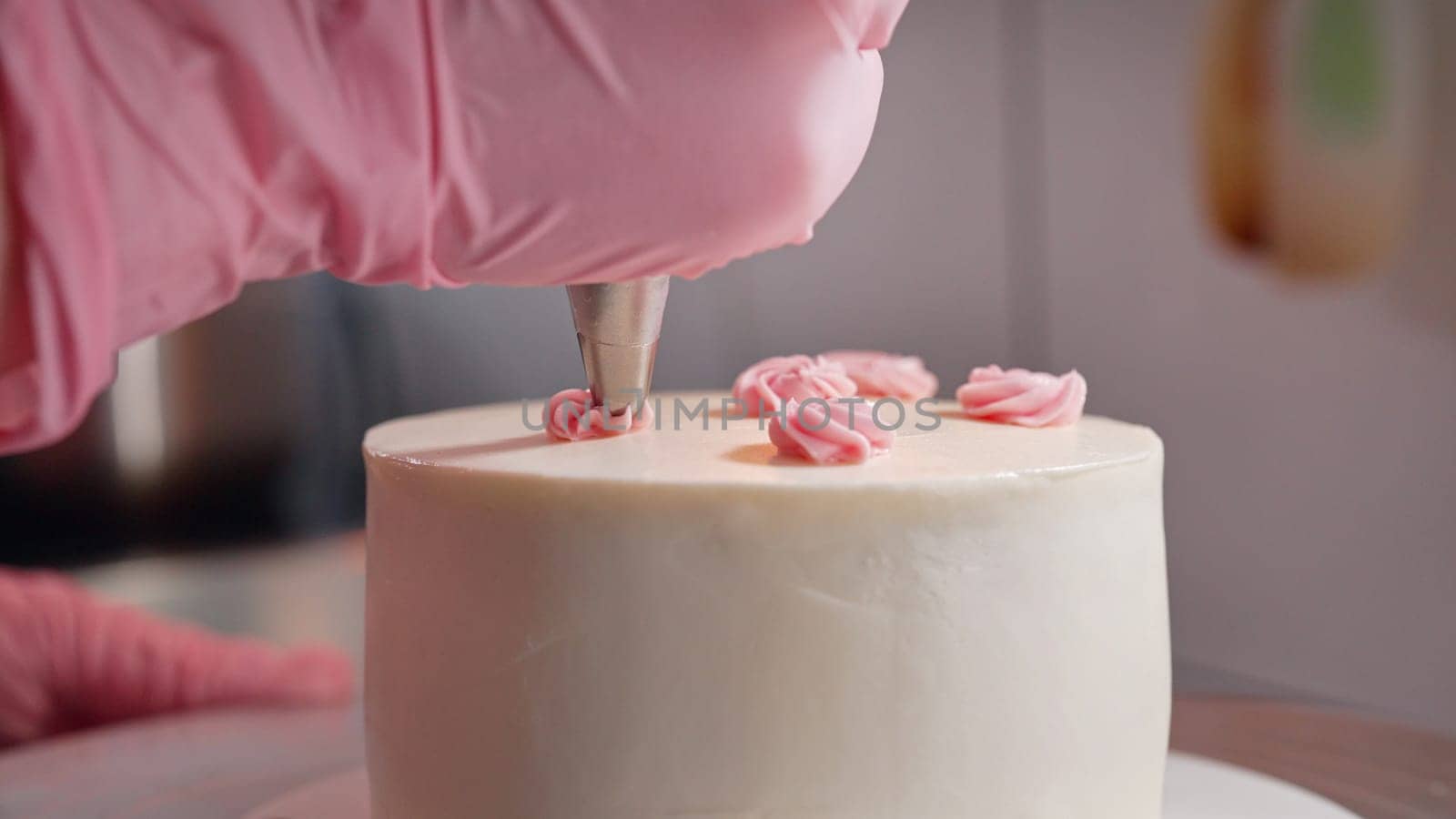 Unrecognizable Woman Chef Decorating Bento Biscuit White Cake with Cream Rose Flowers And Leaves. Pastry Art, Floral Details. High quality