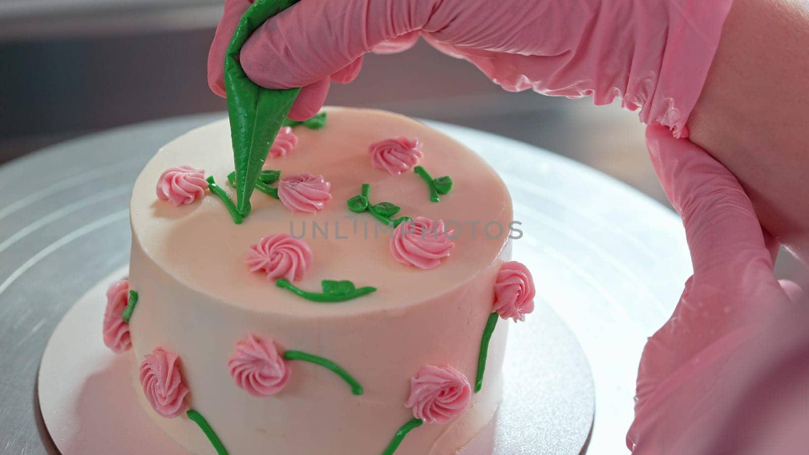 Unrecognizable Woman Chef Decorating Bento Biscuit White Cake with Cream Rose Flowers And Leaves. Pastry Art, Floral Details. High quality