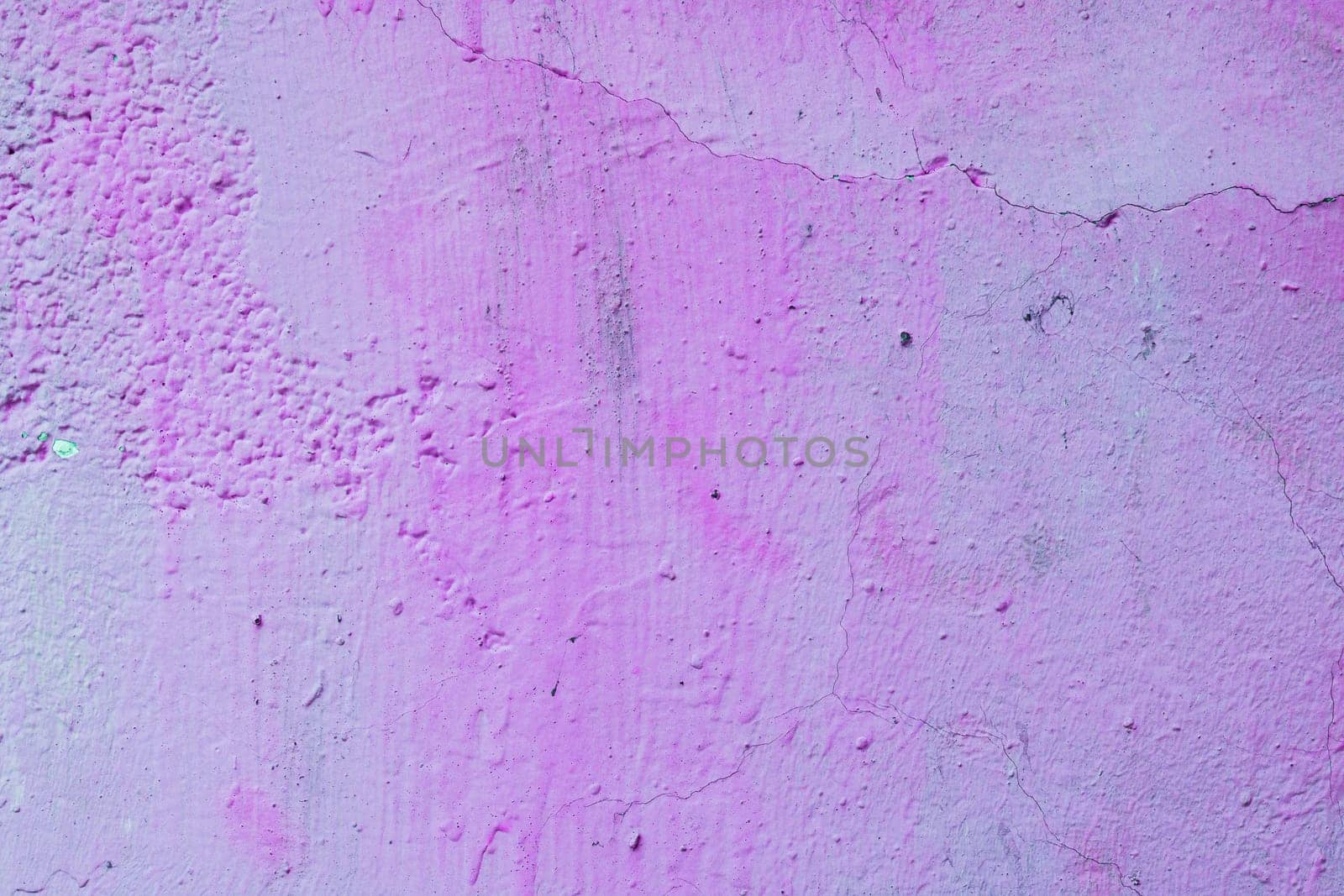 Old, worn wall with stains. Abandoned purple wall.