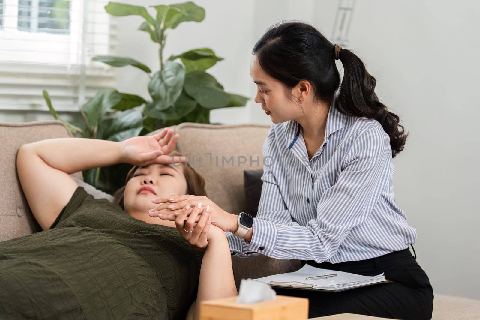 During a one-on-one session, a mental health professional gently holds her client's hand, offering compassion and understanding to help ease emotional pain.