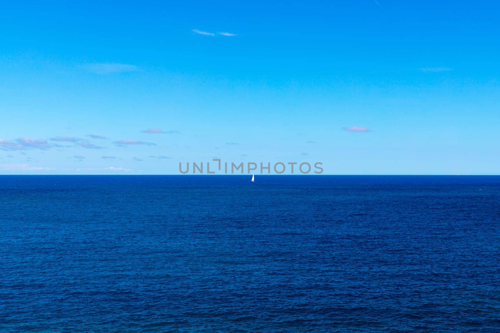 Beautiful seascape of the Adriatic Sea with a sailboat barely visible in the distance