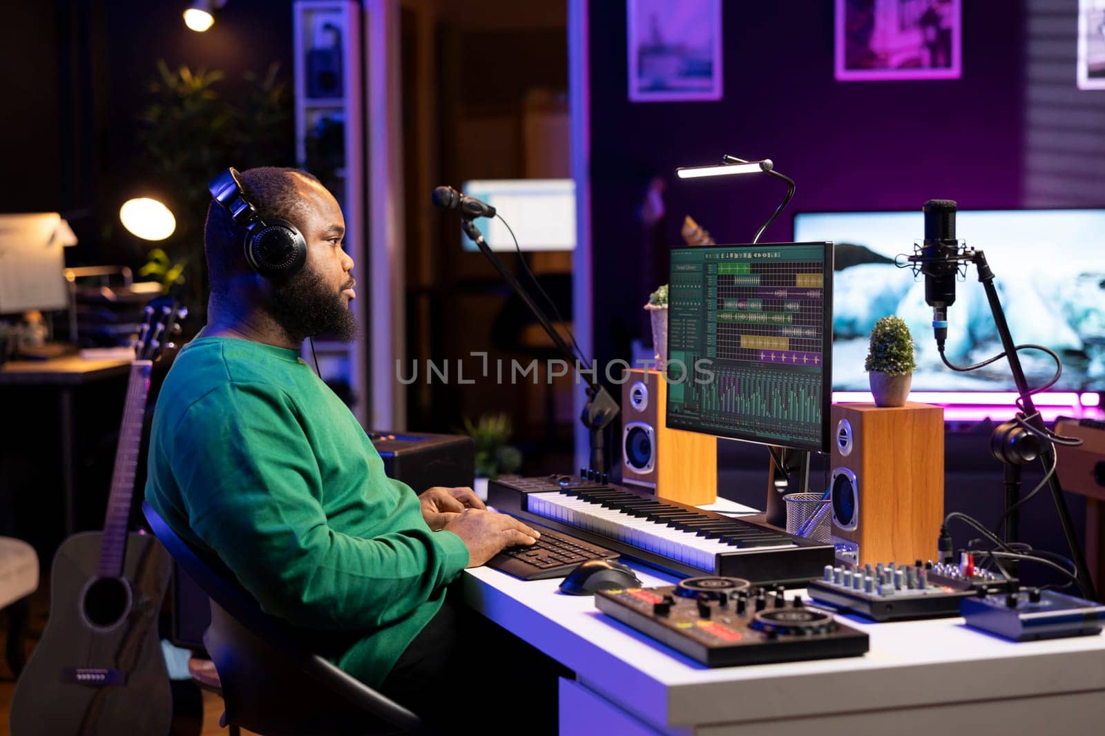 Audio engineer working on editing old recordings in home studio, mixing and mastering on digital software. Young producer operating on stereo console and equipment, music industry.