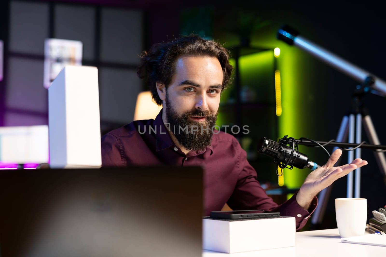Tech guru filming technology review of newly launched cellphone, doing unboxing video and presenting specifications to viewers. Content creator showing mobile phone box to subscribers