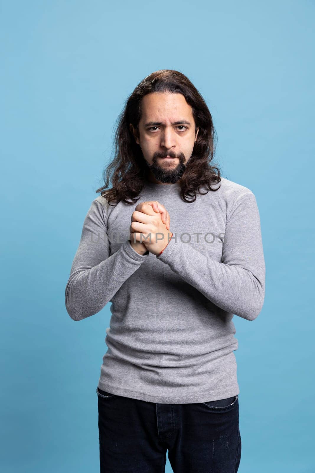 Confident serious person feeling enthusiastic about something on camera, being ecstatic with a vibrant ambitious attitude. Middle eastern guy being self assured and satisfied or pleased.