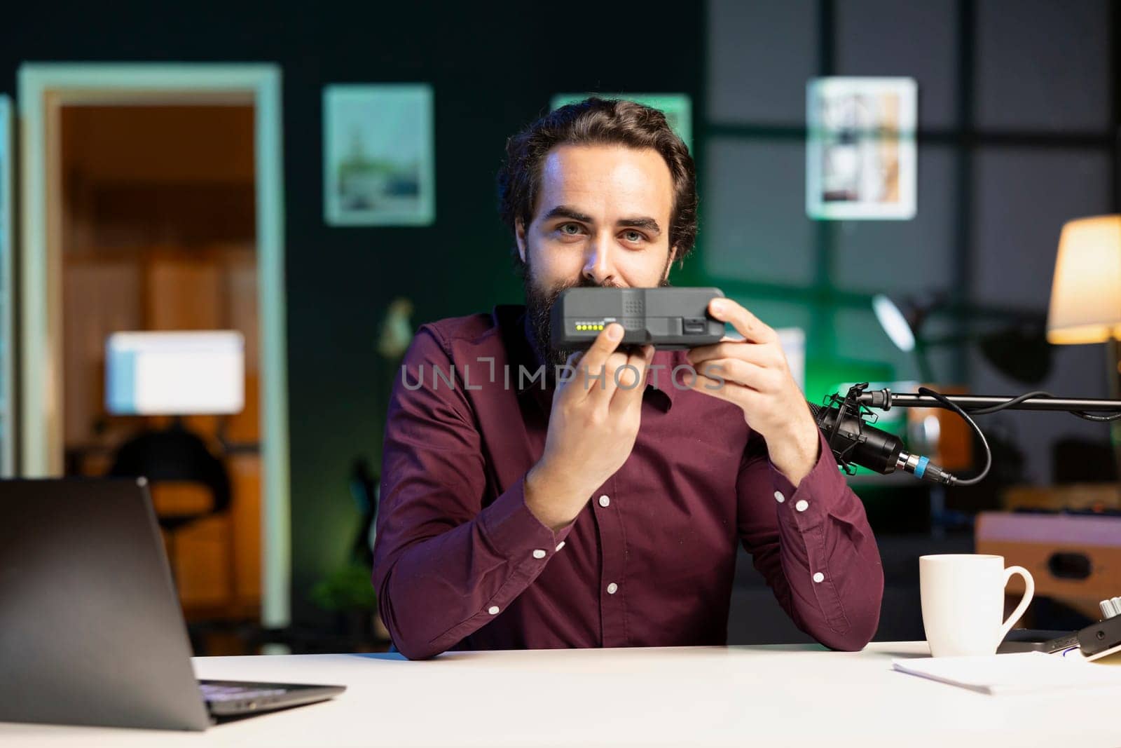 Tech specialist filming video review of newly released portable V mount battery in home studio. Online star recording unboxing of lithium li-ion charging gadget for subscribers