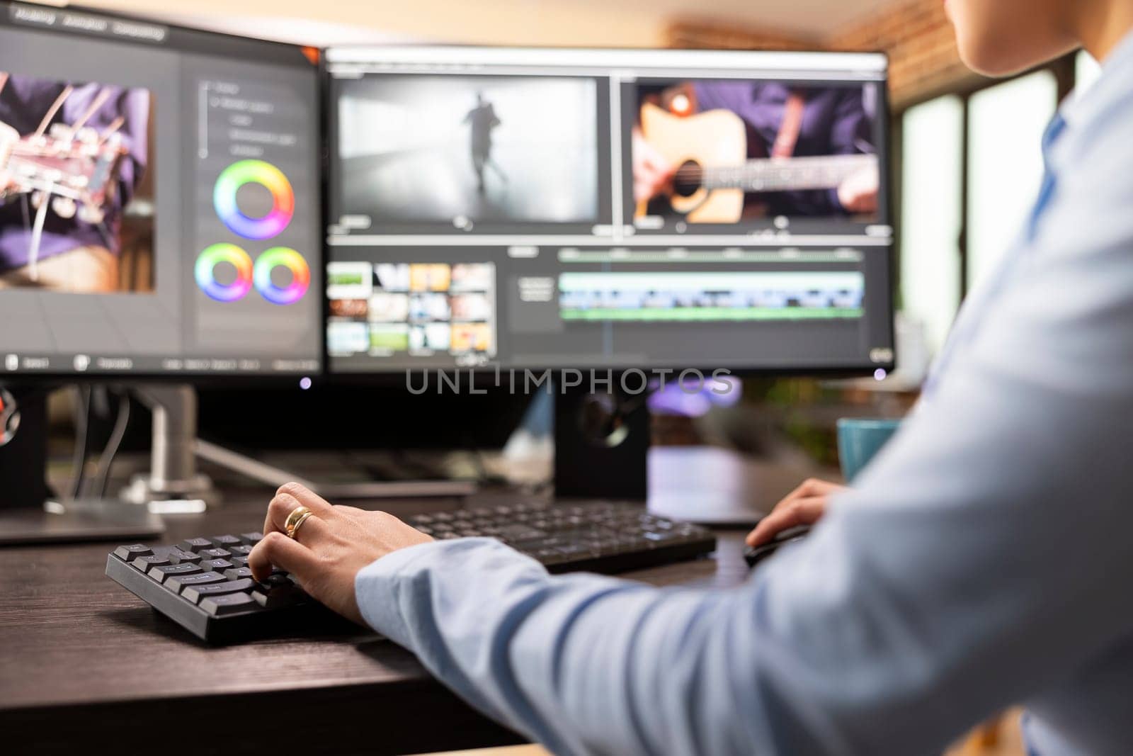 Closeup of video editor with hand on keyboard, using advanced software to refine movie footage. Professional filmmaker working with multi monitor, adjusting film frames to improve cinematic quality.