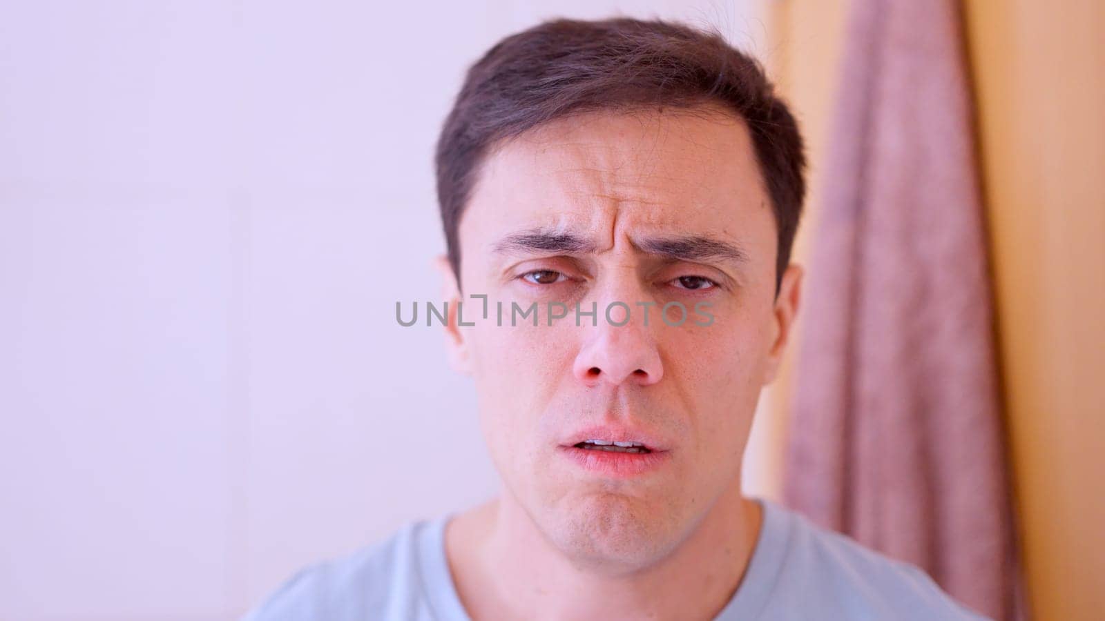 Man suffering from physical discomfort at home