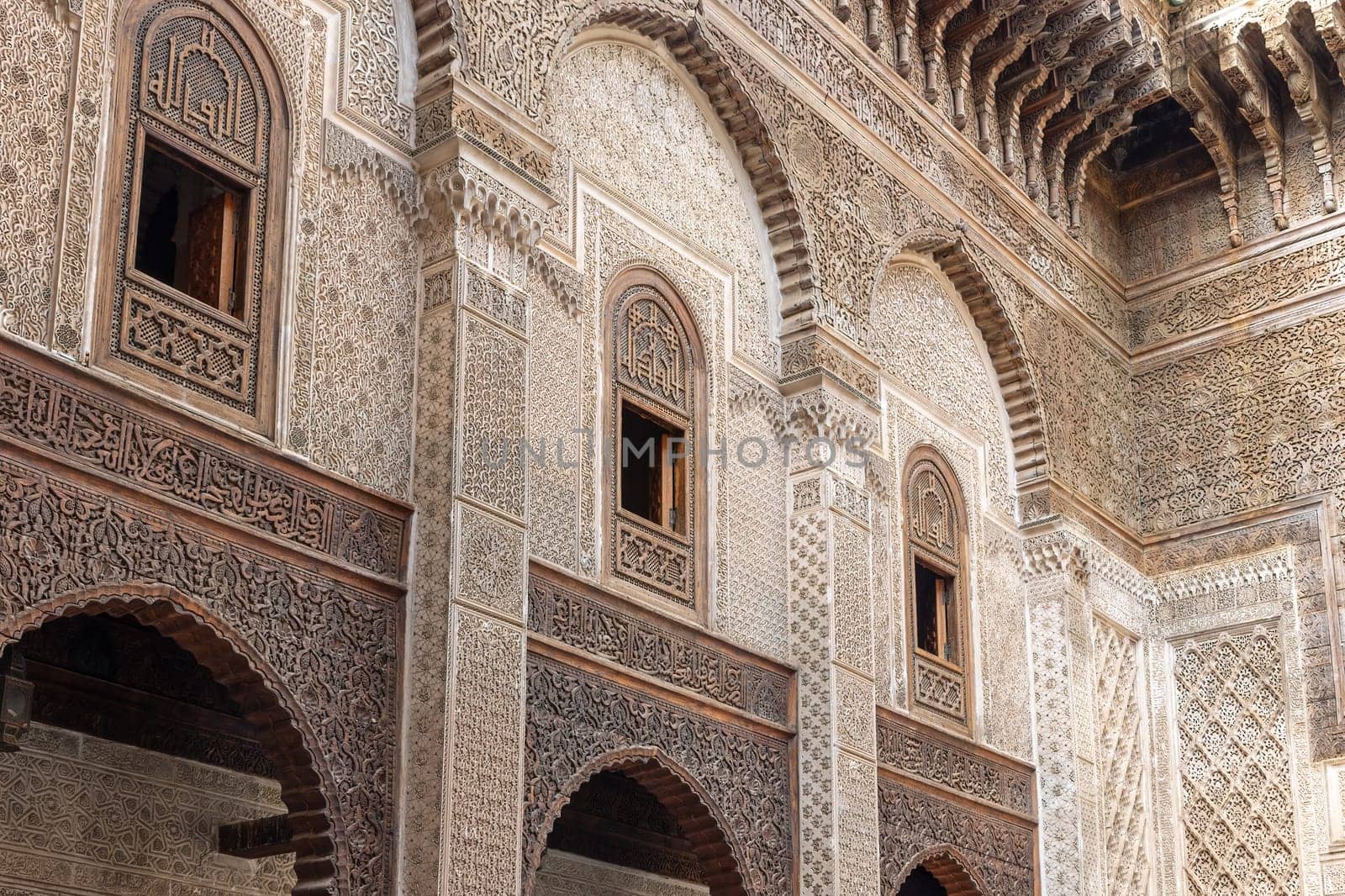 Closeup view of rich decorated facade in the courtyard of the Al-Attarine Madrasa in Fes. Morocco. Horizontally. 