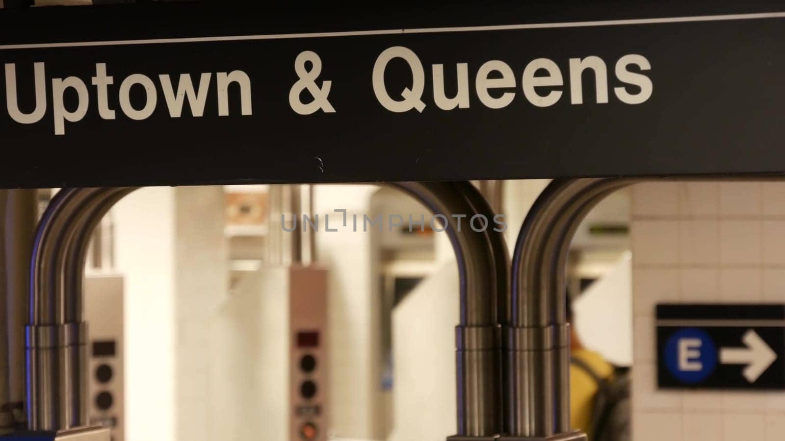 New York City, United States - 31 Aug 2023: Subway station interior. Text sign: Uptown, Queens. Manhattan underground metropolitan. Metro transport navigation. Public passenger railway. Entrance, exit