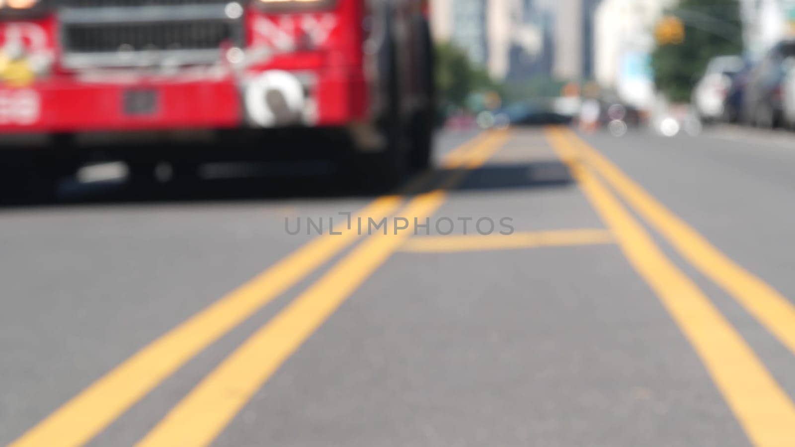 New York City, United States - 2 Sept 2023: Manhattan Midtown cityscape from Queens, Long Island, USA. FDNY firefighters truck on street, yellow dividing line, road marking. Fire department firetruck.