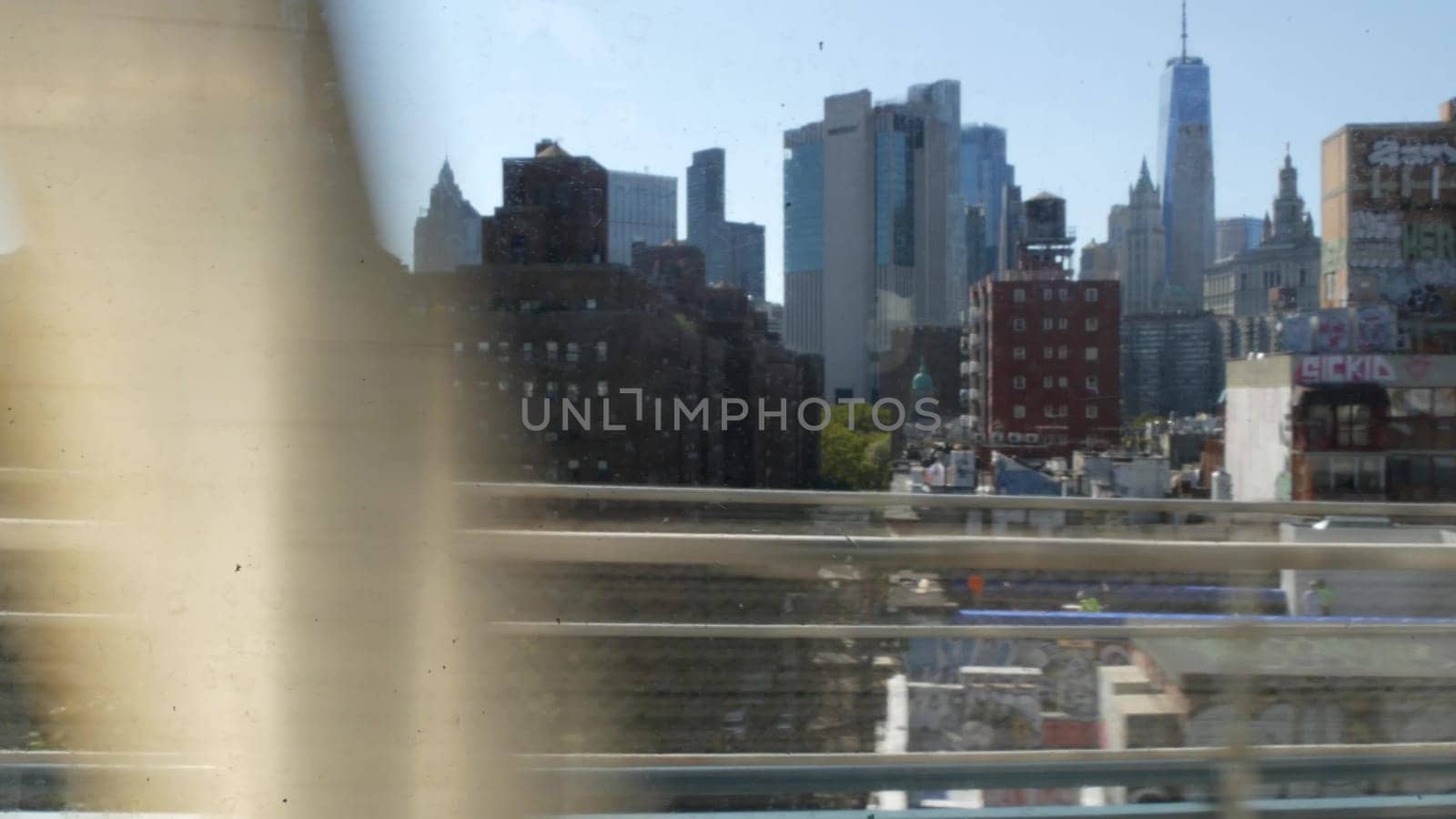 New York City, United States - 14 Sept 2023: Subway train, Manhattan bridge. Shaking camera, dirty window. Metro transport metropolitan traffic. Passenger railway. Downtown skyline. World Trade Center