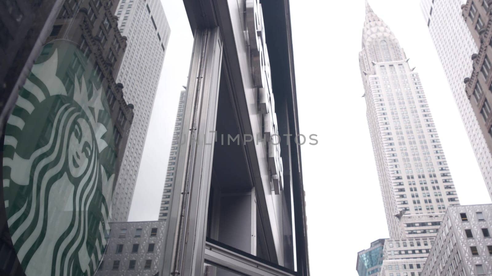 New York City, United States - 29 Aug 2023: Manhattan Midtown street, Lexington Lex avenue. Urban architecture in USA. Starbucks coffee logo, Chrysler building. High-rise skyscraper tower. NYC symbol.