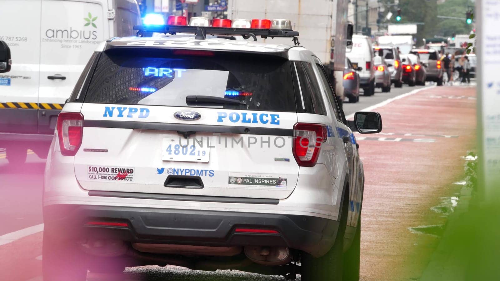 New York City, United States - 29 Aug 2023: Police patrol car, USA NYPD, 911 vehicle on Manhattan Midtown 34th street. American cop auto siren on avenue, urban traffic scene, Herald square in NYC.
