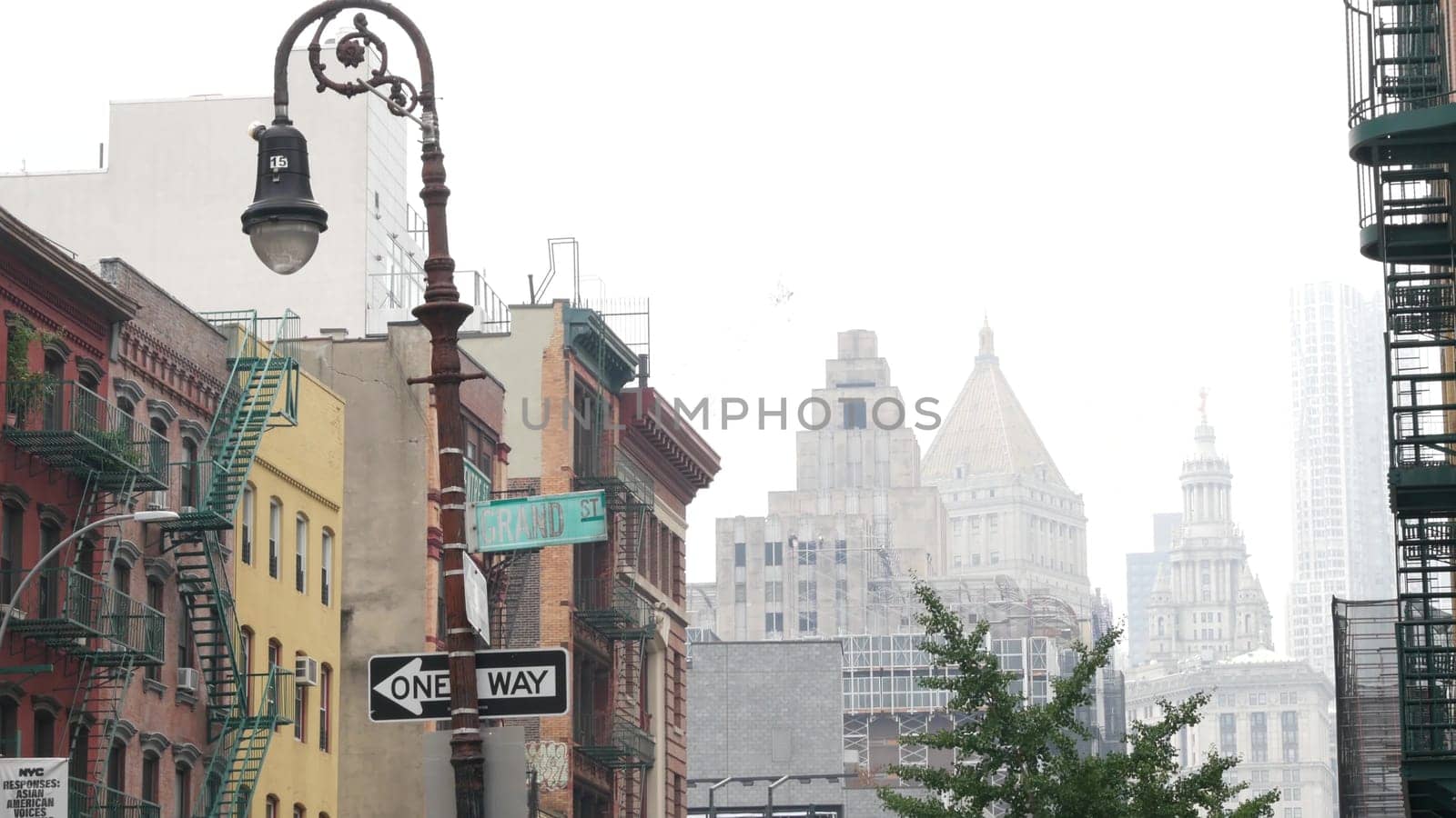New York City, United States - 8 Sept 2023: Manhattan Soho district Grand and Centre street near Broadway. Urban old classic architecture. Civic Center municipal building, USA Court. Lantern in fog.