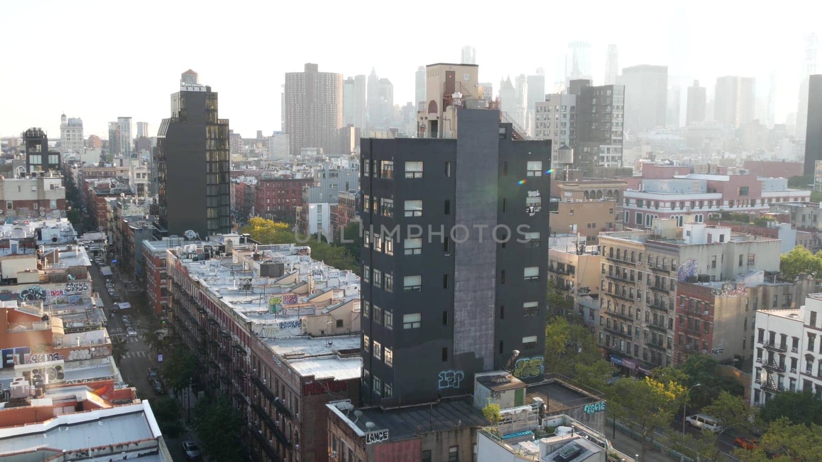 New York City, United States - 7 Sept 2023: Manhattan skyline cityscape. Rooftop graffiti on residential district buildings roofs. NYC Real Estate, urban streets architecture. Lower East Side district