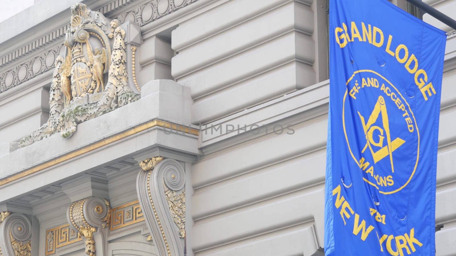 New York City, United States - 6 Sept 2023: Grand Lodge of Masons building facade, Manhattan street. Freemasons headquarters architecture. Masonry organization in NYC, USA. Masonic Hall exterior. Flag