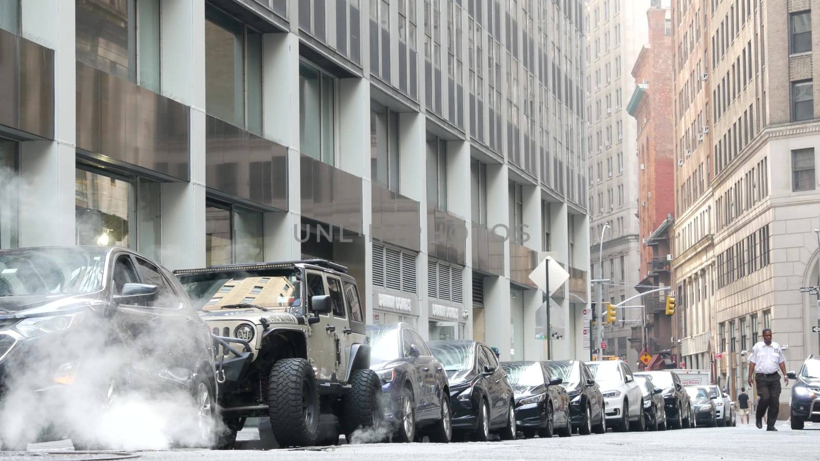 New York City, United States - 9 Sept 2023: Hot smoke from manhole, Con Edison's Steam system. Vapor from road, car on Beaver Street, NYC Downtown Financial District, Lower Manhattan, USA. Urban scene