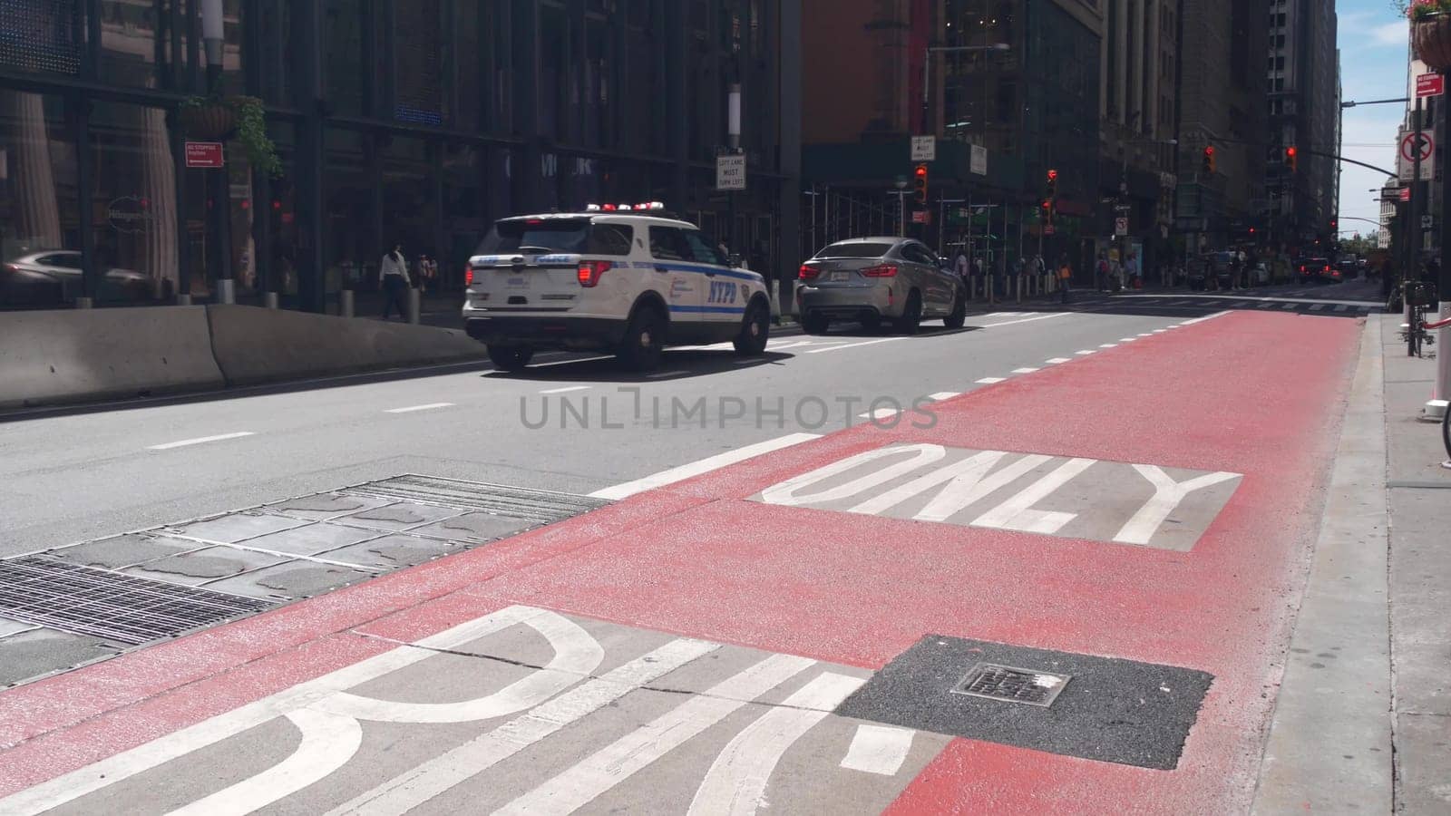 New York City, United States - 31 Aug 2023: Police department patrol car, USA NYPD, 911 vehicle on Manhattan Midtown street. American cop auto on avenue, urban road traffic in NYC. Bus only red lane.