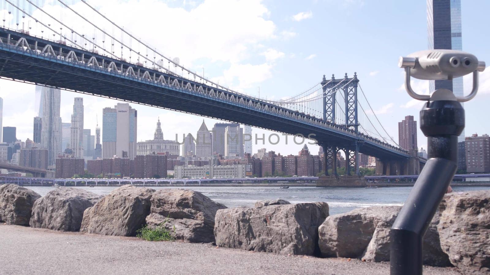 New York City, United States - 30 Aug 2023: Manhattan Bridge lookout, tower viewer binoculars, Brooklyn Dumbo. Waterfront downtown cityscape, skyscraper skyline. East River tourist promenade.