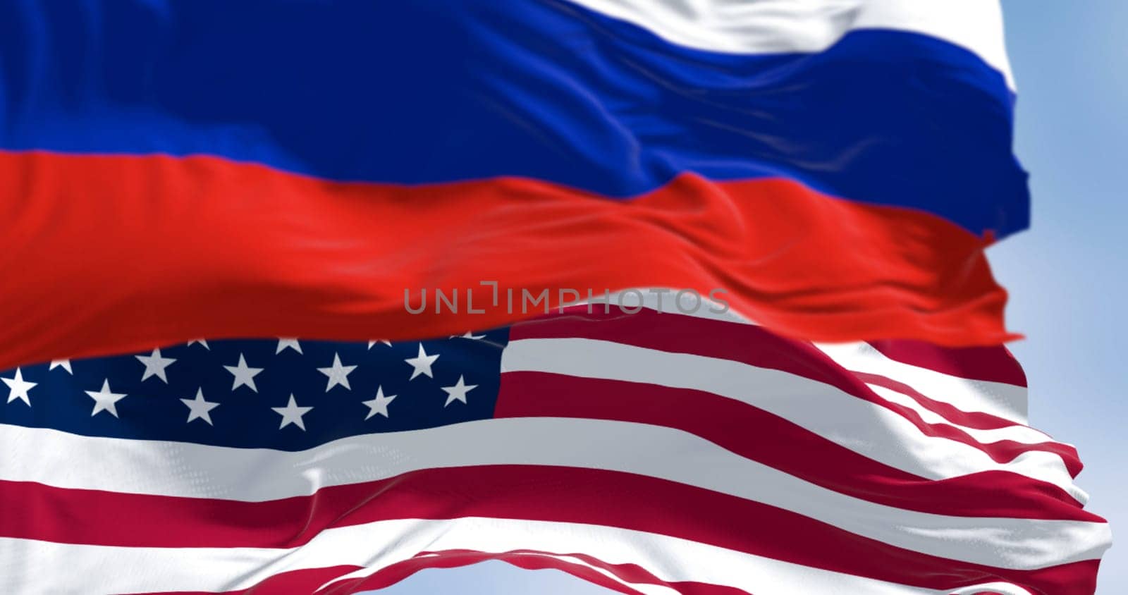 3D render of Russian and American flags fluttering in the wind, symbolizing diplomacy, identity, and international relations on a bright day.