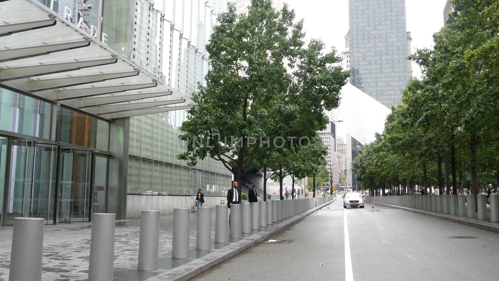 New York City, United States - 10 Sept 2023: Manhattan Downtown Financial District. People near World Trade Center Oculus. Memorial pools and 911 Museum area, Fulton street architecture in USA. Trees.