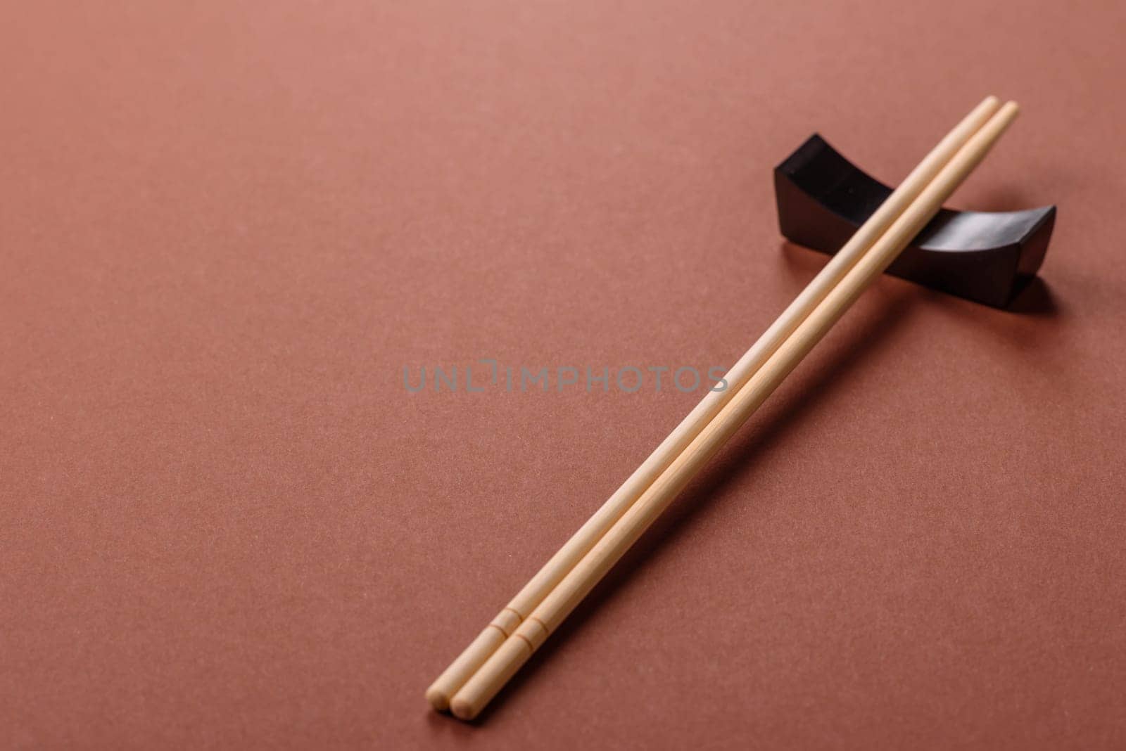 Chopsticks for sushi or other Japanese or Chinese food on a brownstone table. Asian chopsticks