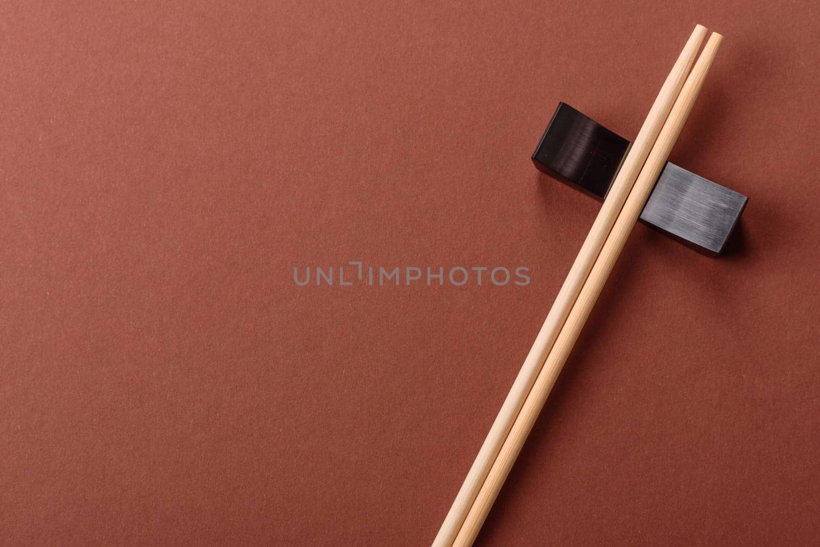Chopsticks for sushi or other Japanese or Chinese food on a brownstone table. Asian chopsticks