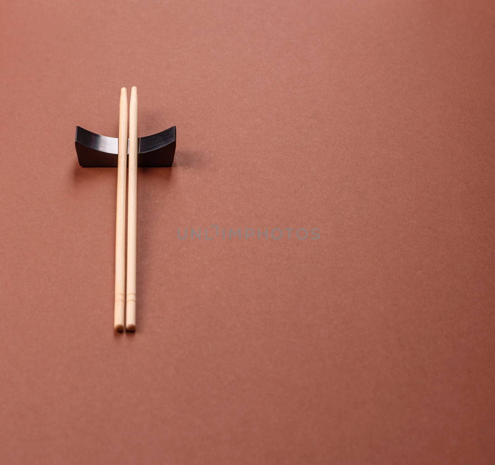Chopsticks for sushi or other Japanese or Chinese food on a brownstone table. Asian chopsticks