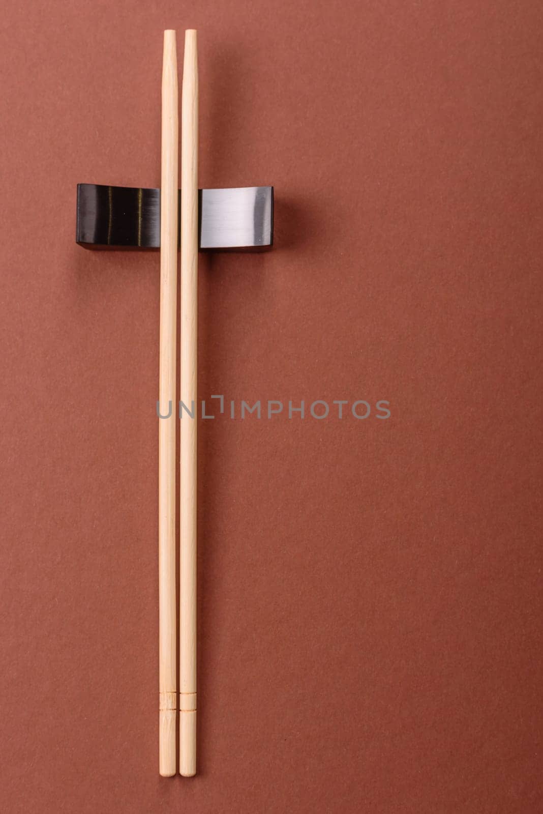 Chopsticks for sushi or other Japanese or Chinese food on a brownstone table. Asian chopsticks