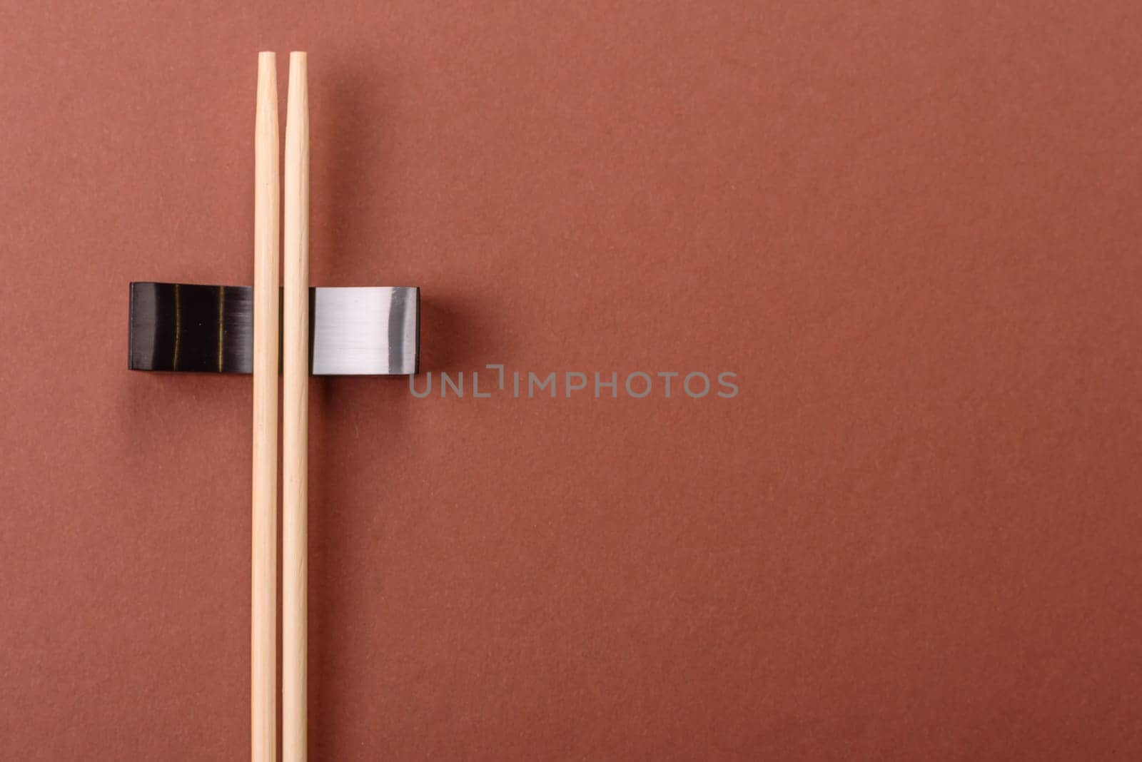 Chopsticks for sushi or other Japanese or Chinese food on a brownstone table. Asian chopsticks