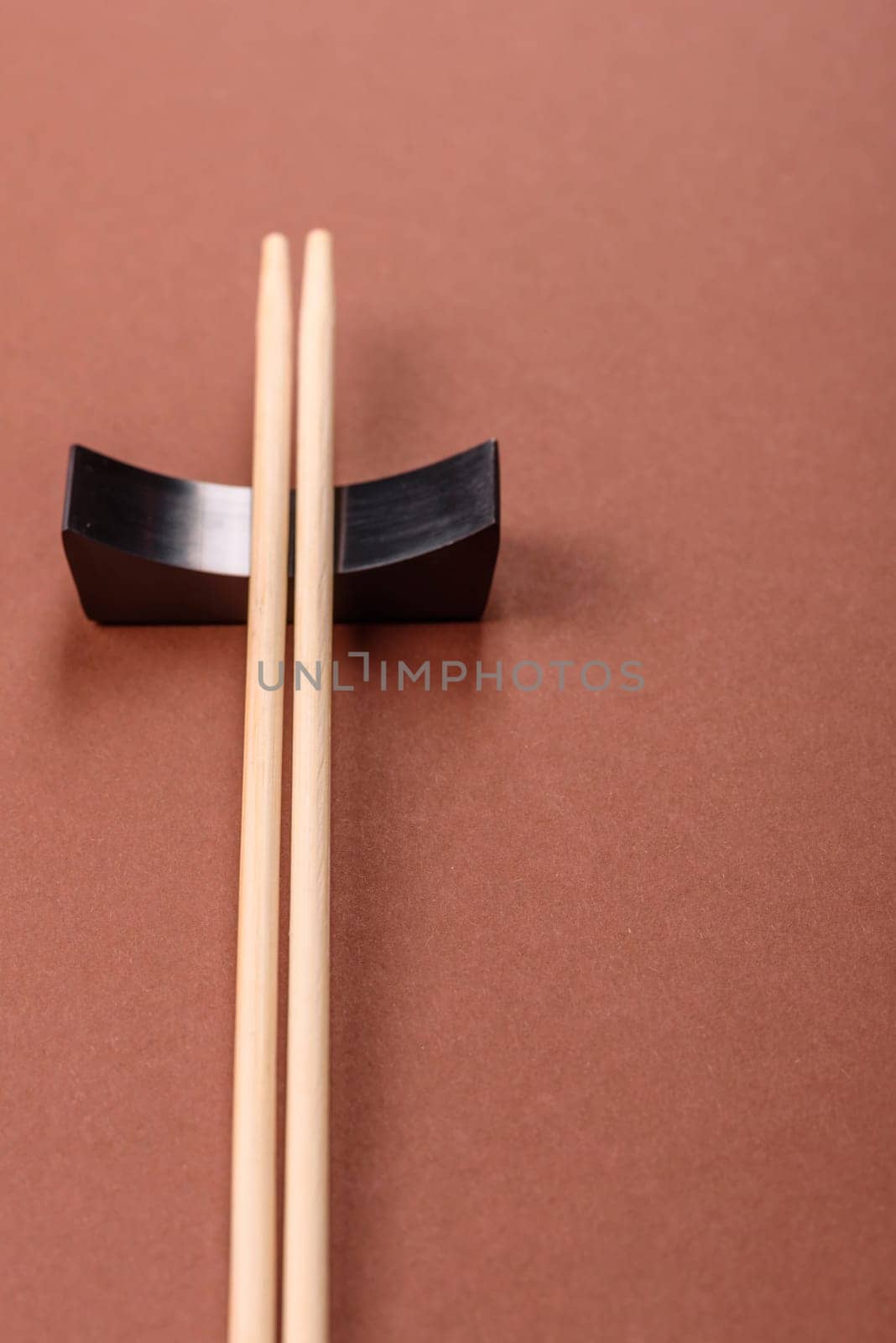 Chopsticks for sushi or other Japanese or Chinese food on a brownstone table. Asian chopsticks