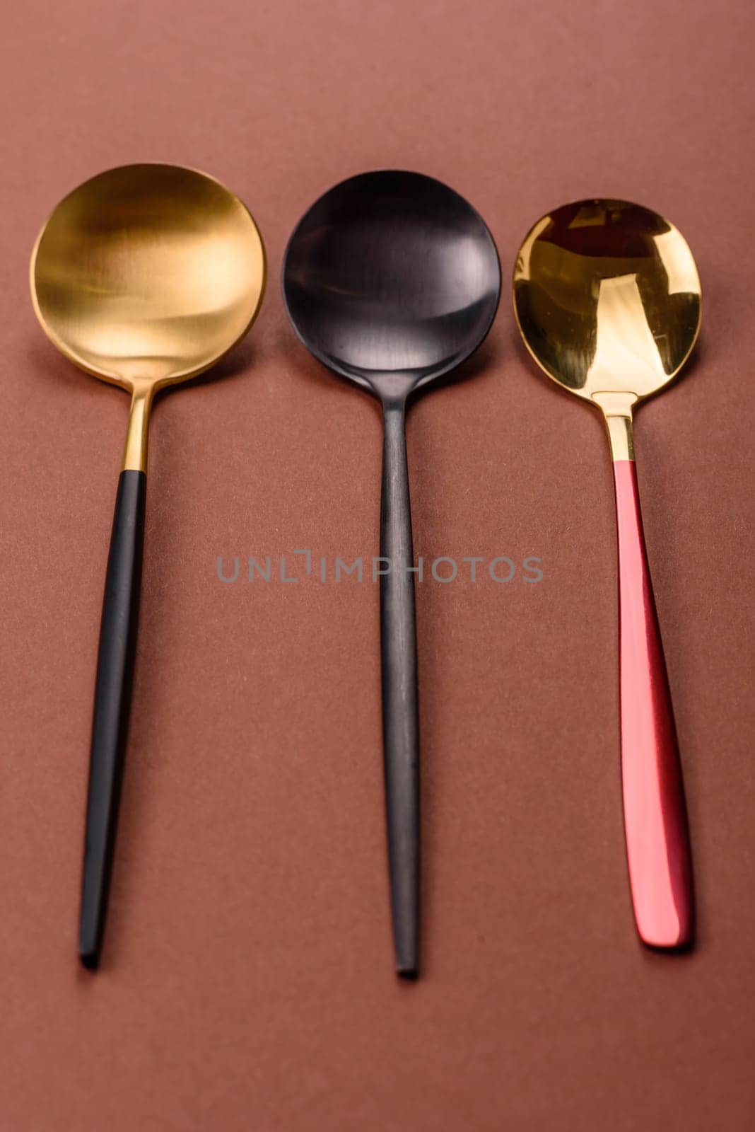 Empty metal spoon on a monochrome brown background. Cutlery on the dining table