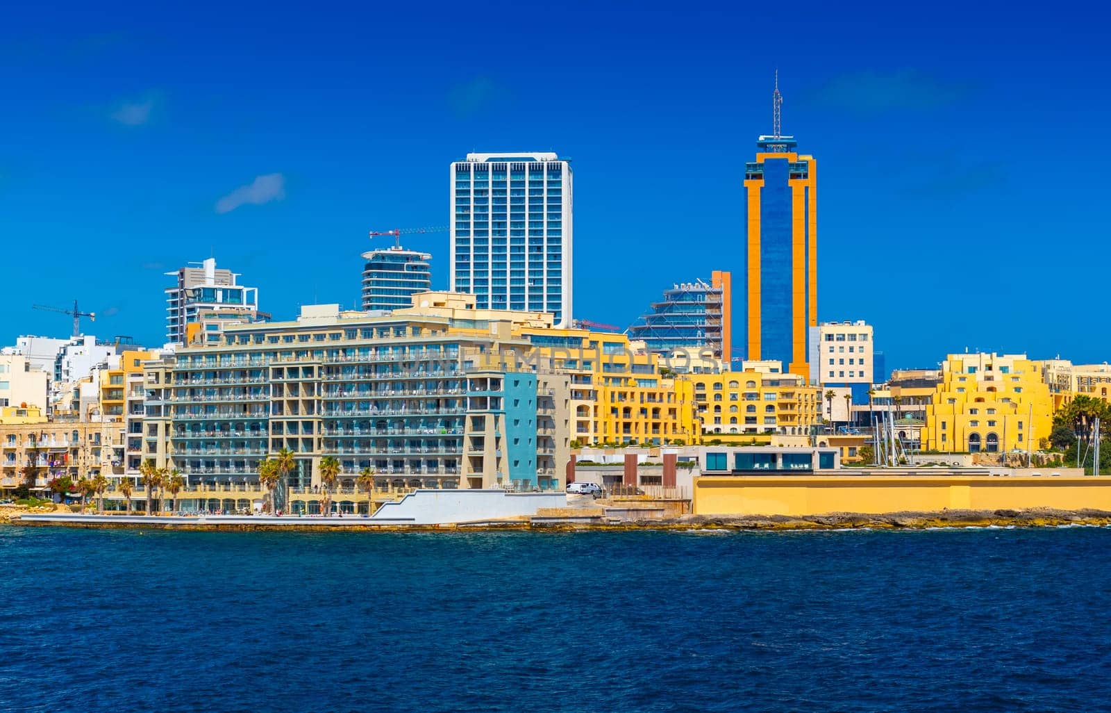 Cityscape of Saint Julian's with modern hotel buildings and skyscrapers viewed from the Sea, Malta