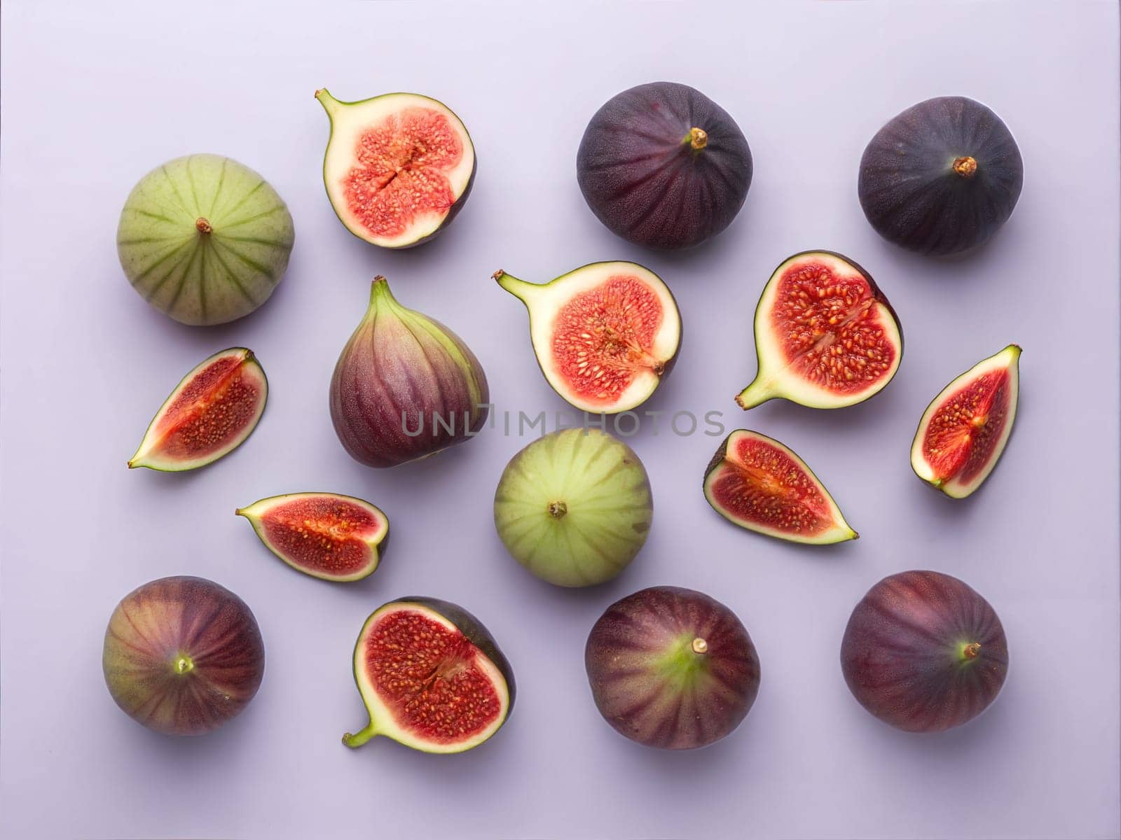 A flat lay of fresh figs, both whole and halved, arranged beautifully on a light purple background. Perfect for showcasing fresh fruit, healthy eating, and culinary styling.