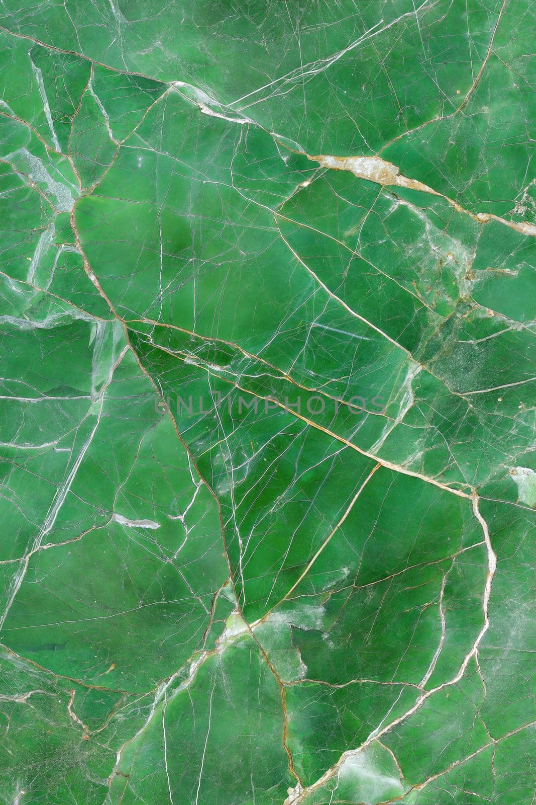 A high-detailed green marble background featuring natural veins and cracks, perfect for luxury design and creative projects.